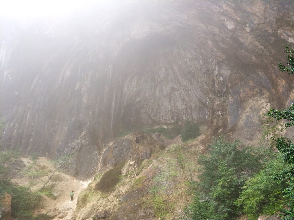 Niño minúsculo a los pies de la cueva de las gralles
